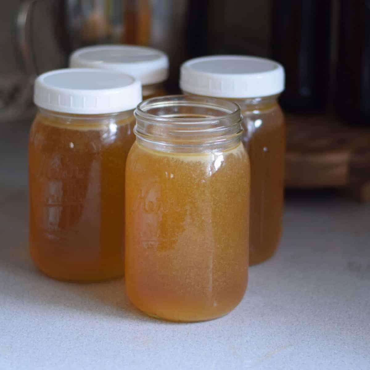 4 mason jars filled with fresh bone broth