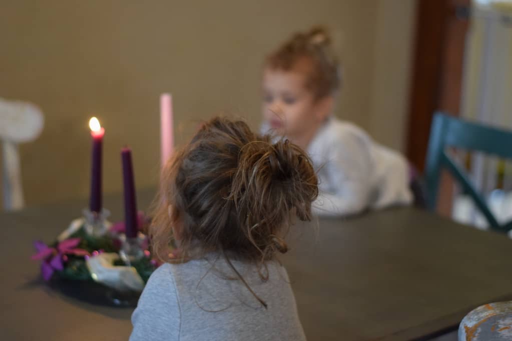 two little girls admiring the completed advent wreath