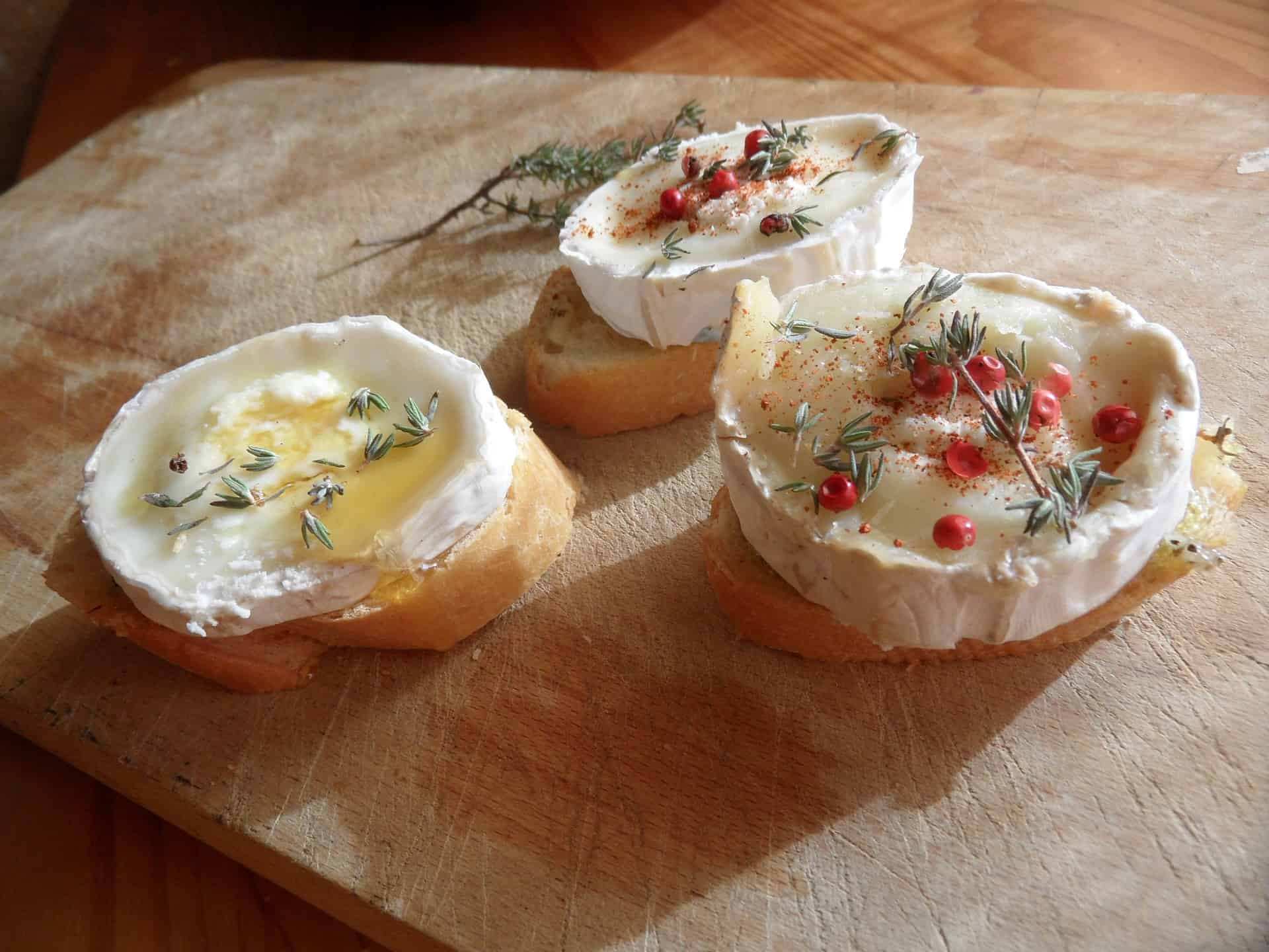 goat cheese on small pieces of bread and displayed on a wooden serving platter