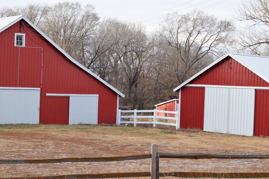 two red barns on a farm