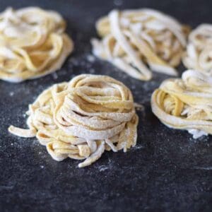 homemade pasta noodles on a black countertop