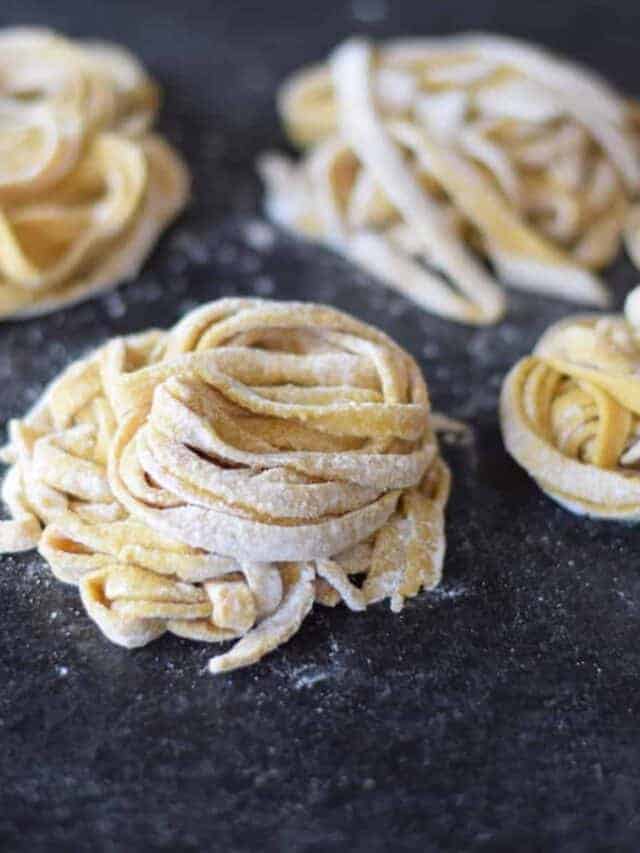 homemade pasta noodles on a black countertop