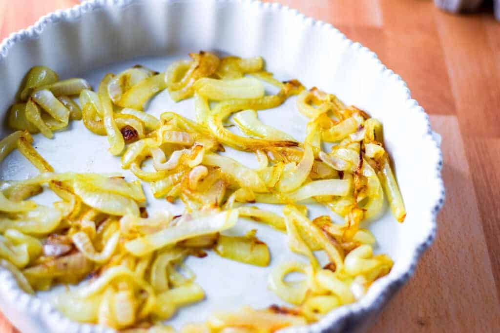caramelized onions in a white baking dish