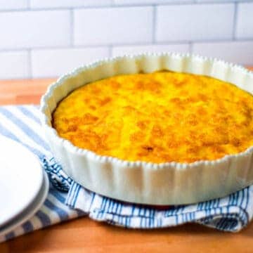 finished quiche in a white pie dish