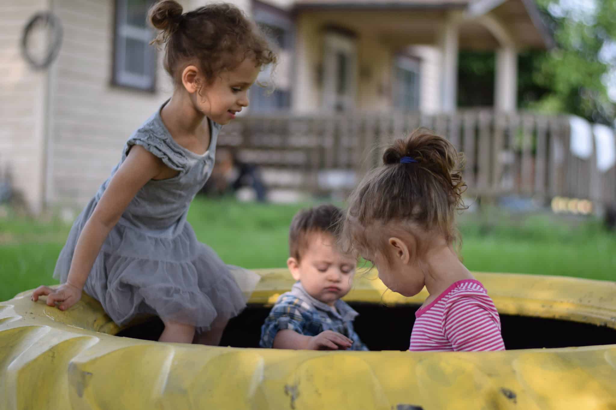 little children playing in a sandbox