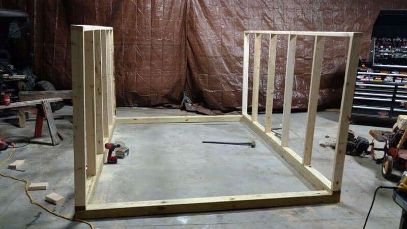 The wall frames of the greenhouse being constructed inside of the shop. 