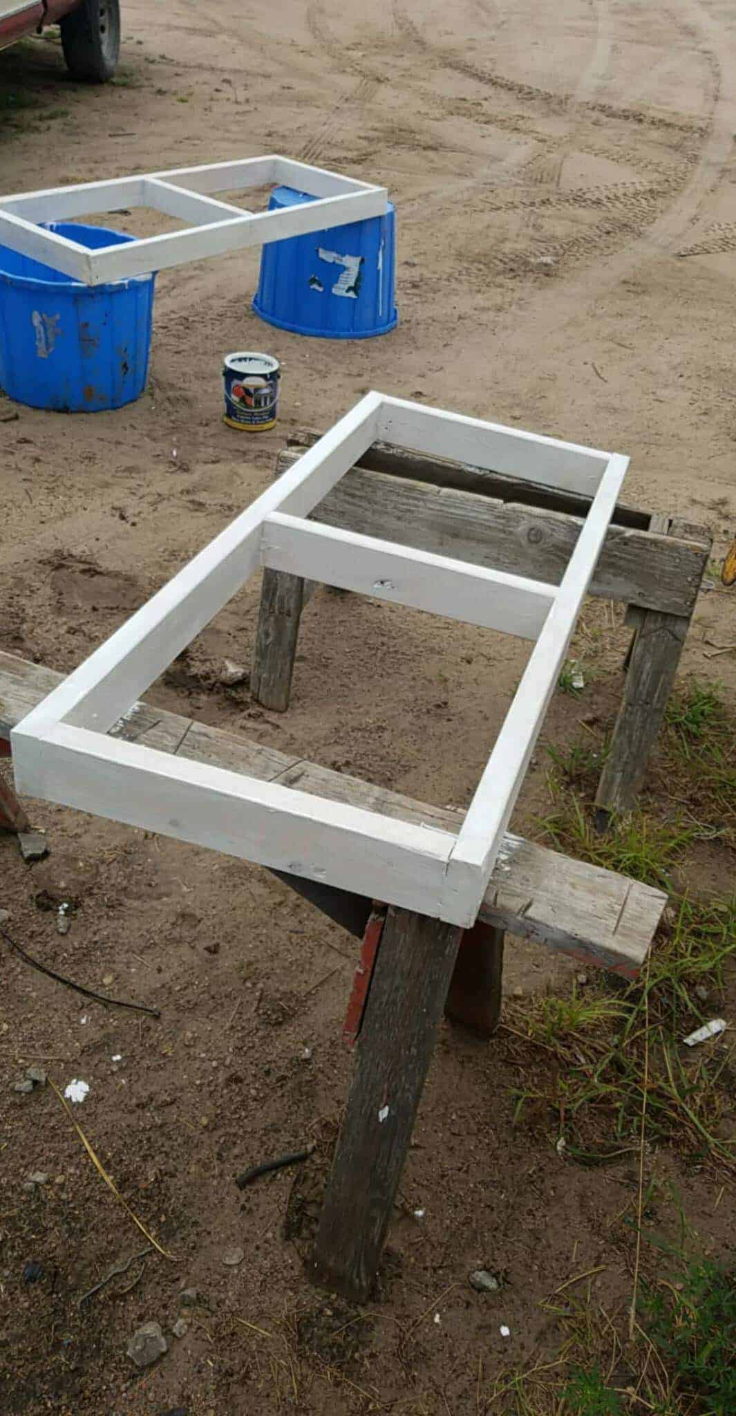 Two of the vents being built and painted white, being displayed outside before being installed in the greenhouse.