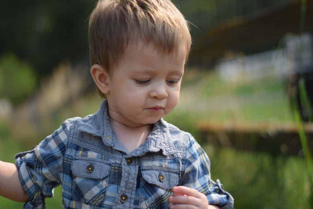 little toddler boy playing outside