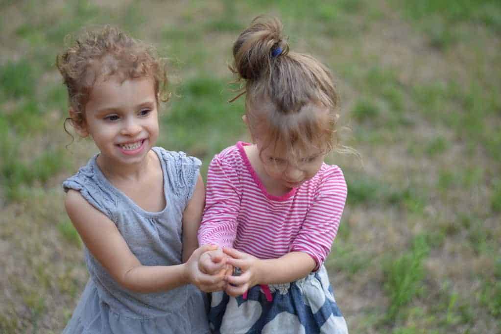 two little girls playing outside