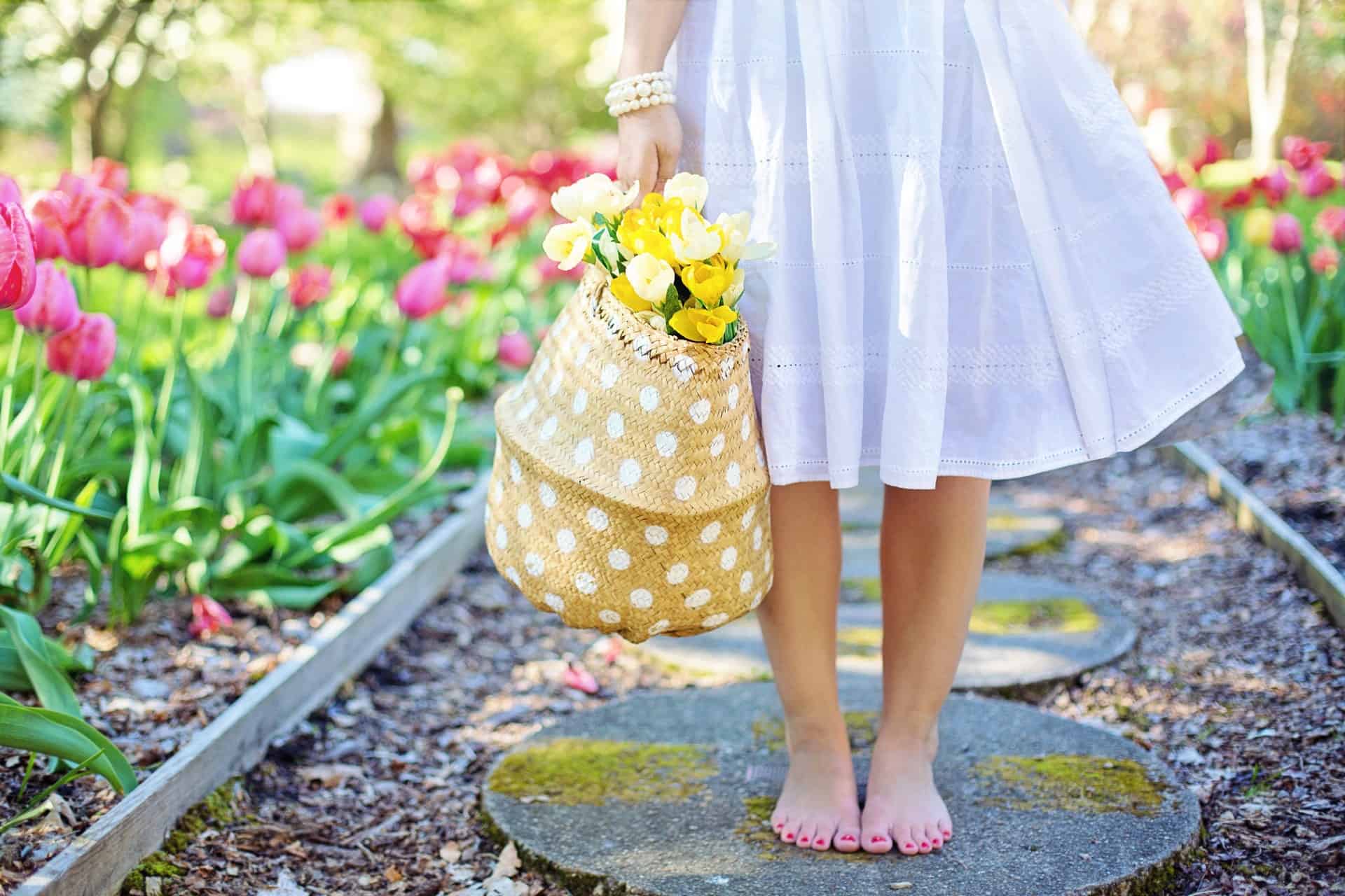 garden with pink tulips and lady wearing full modest skirt