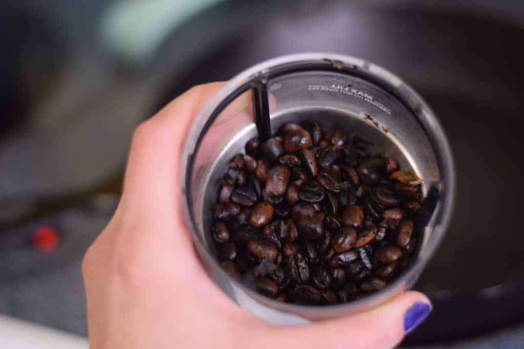 freshly roasted beans in a coffee grinder