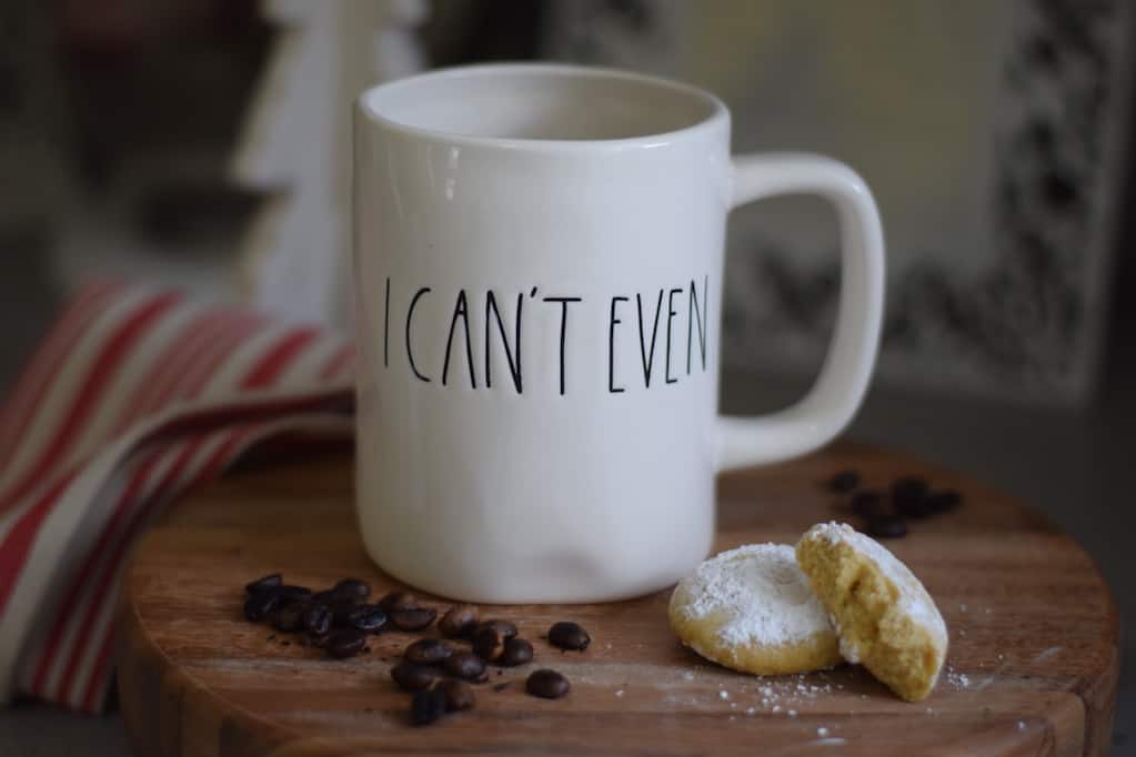 coffee beans and a coffee mug on a wooden board