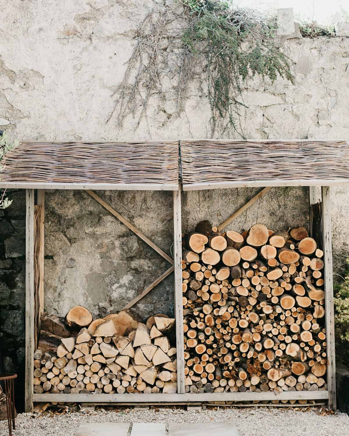 cut wood stacked on the side of the house, outside.