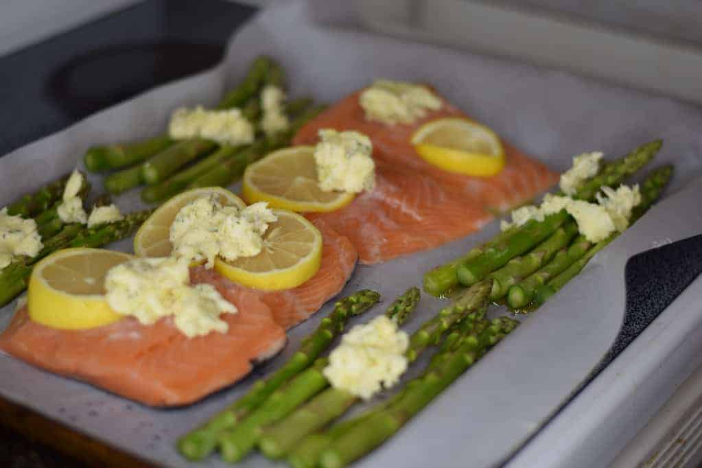 salmon and asparagus on a baking sheet