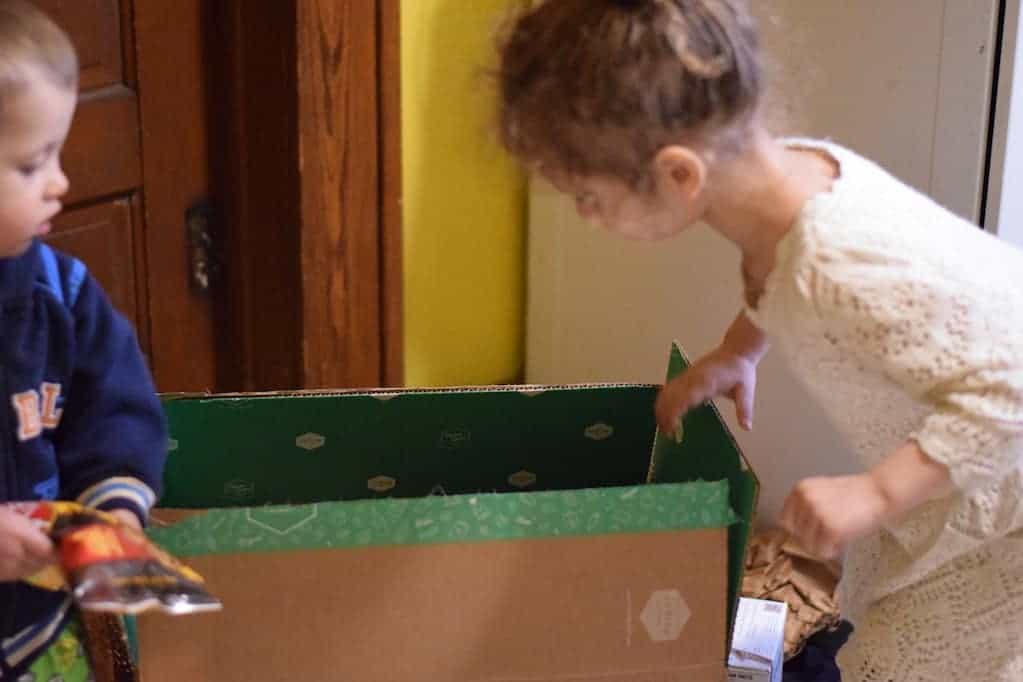 children helping unpack groceries
