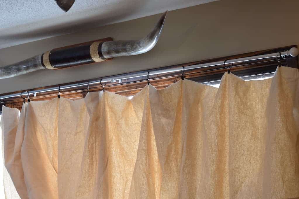 Drop cloth curtains hanging from curtain rod