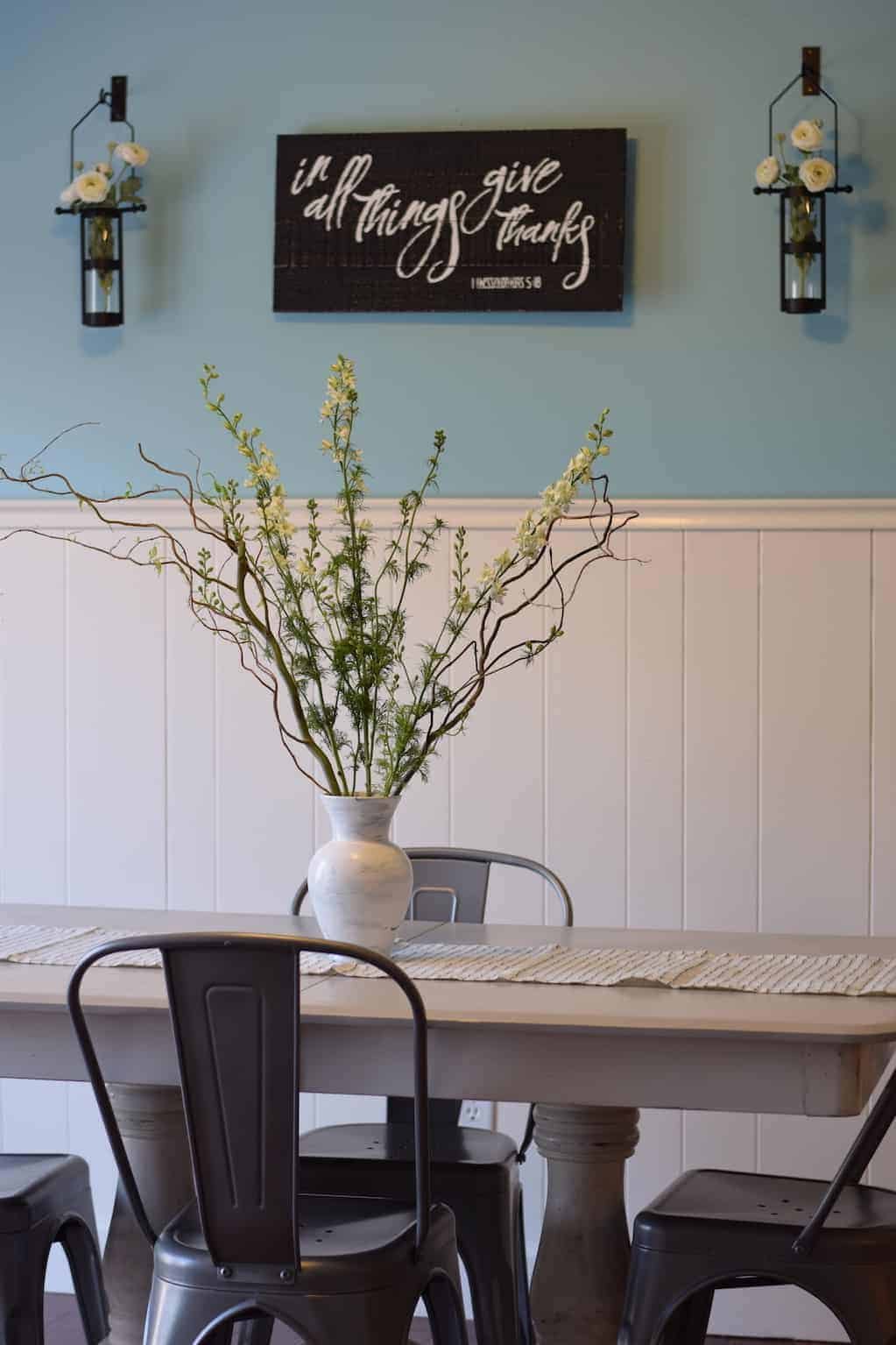 farmhouse dining room table with willow branches and spring decor