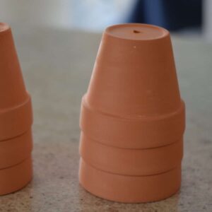 stack of terra cotta pots on counter