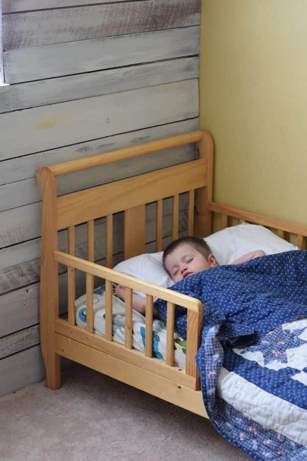 toddler boy sleeping in bed