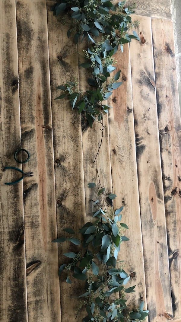 eucalyptus greenery at edge of length of table