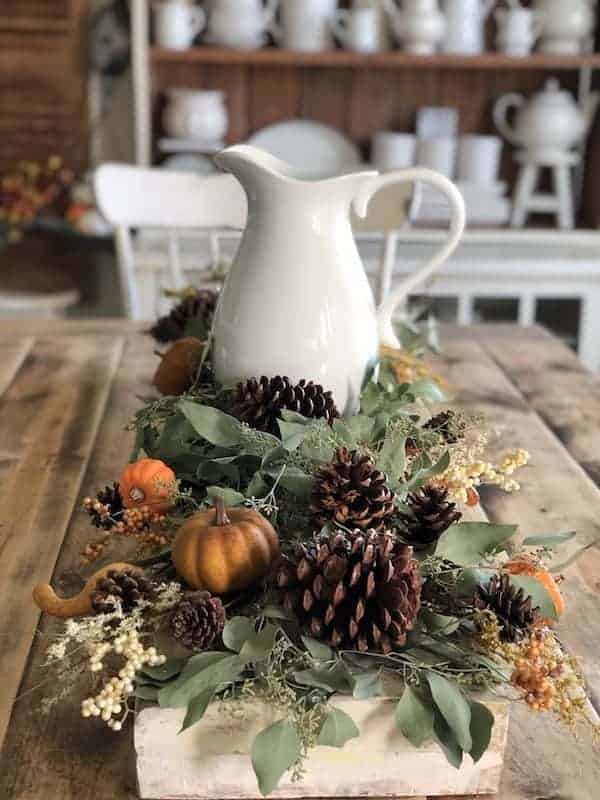 Completed fall tablescape with a white farmhouse pitcher added to the center