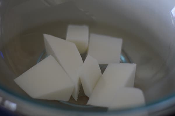 cut up pieces of the goat milk soap base added to the double boiler