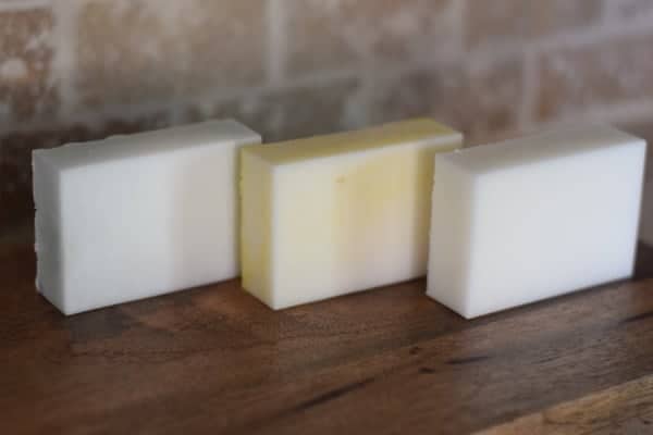 3 of the goat milk soaps finished and resting on a wooden board