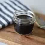 finished homemade elderberry syrup in a small mason jar