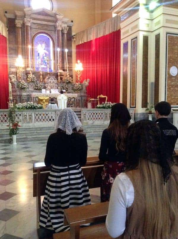 Priest offering mass at the shrine of St Philomena