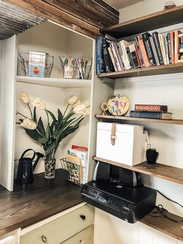 books, arts and crafts on a shelf