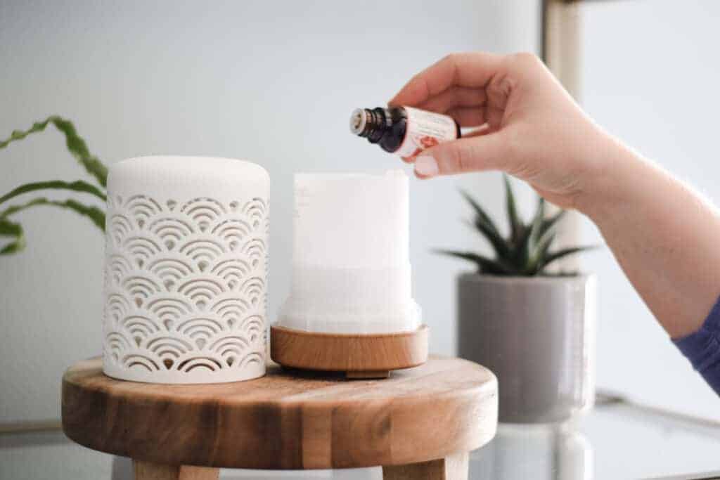 add drops of essential oils to a white diffuser
