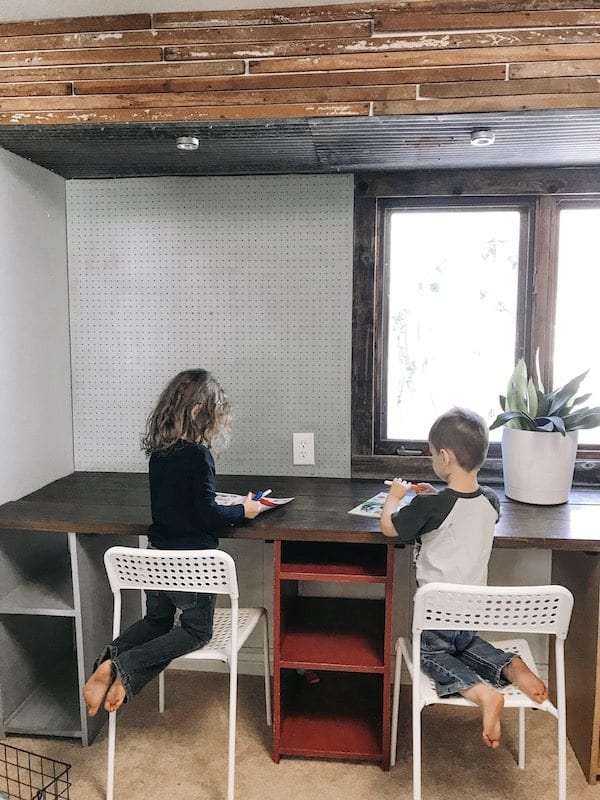 children sitting at a table and doing school work