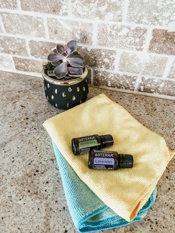 lavender and tea tree essential oil bottles on microfiber towels
