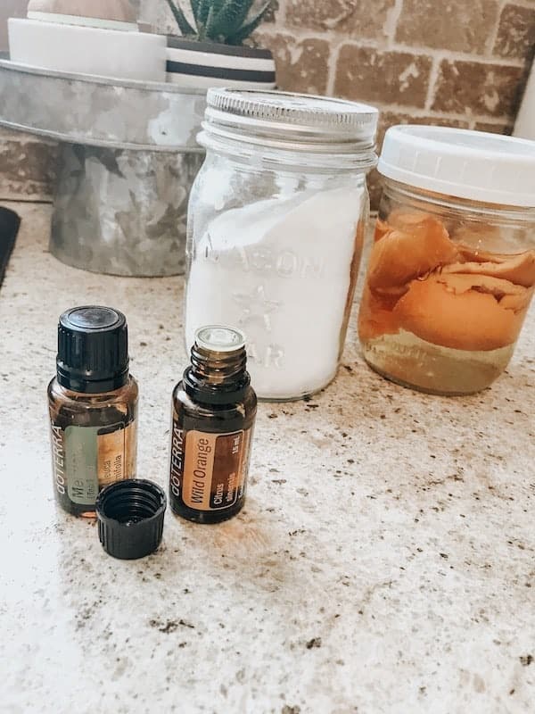 essential oils and baking soda in a glass mason jar