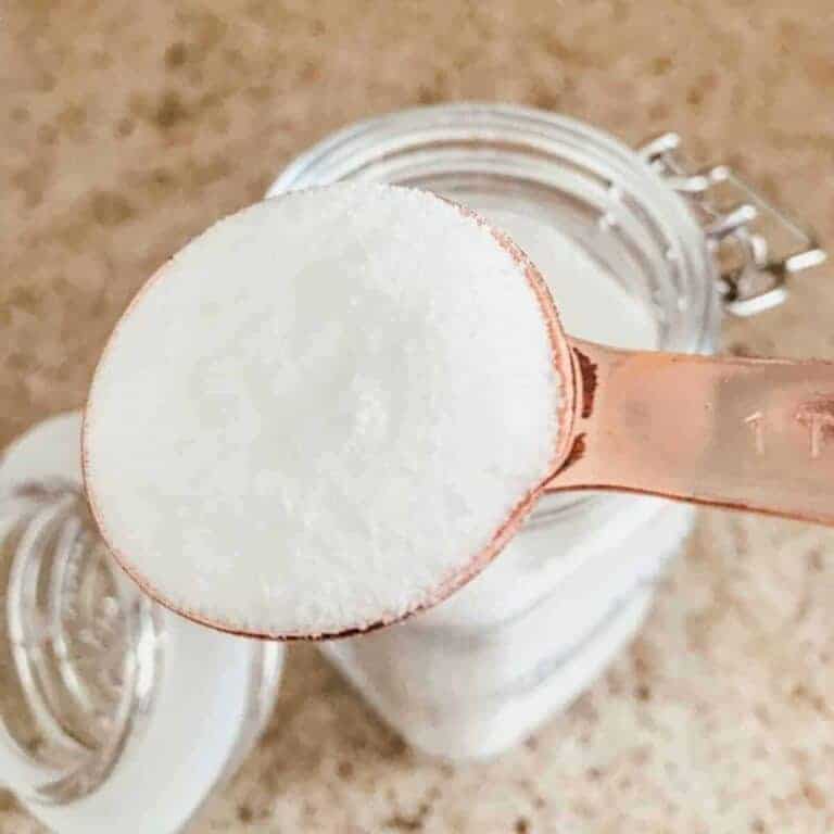 homemade dishwasher detergent in a mason jar and measuring spoon