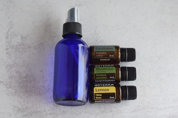 essential oils with blue glass spray bottle