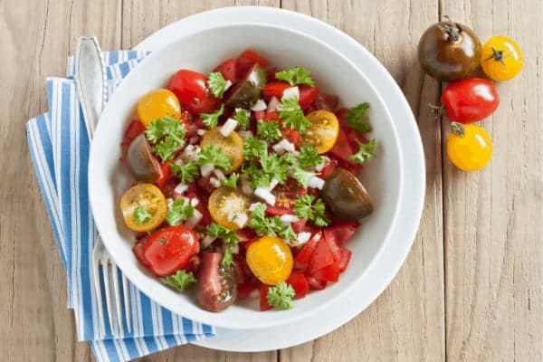 fresh tomato salad in a white bowl