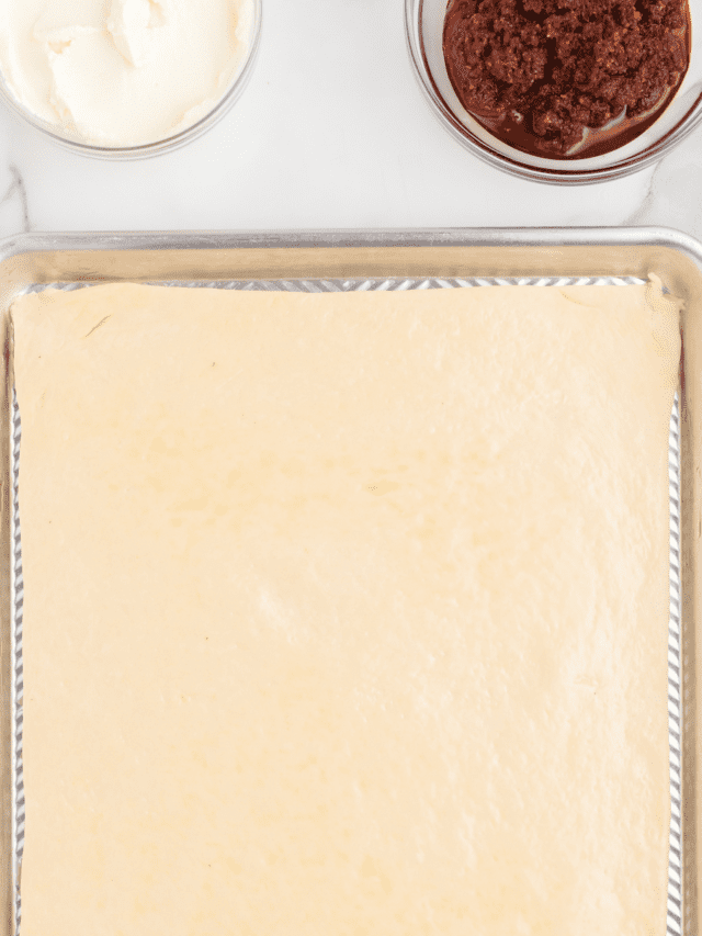 sheet pan with rolled out pizza dough.