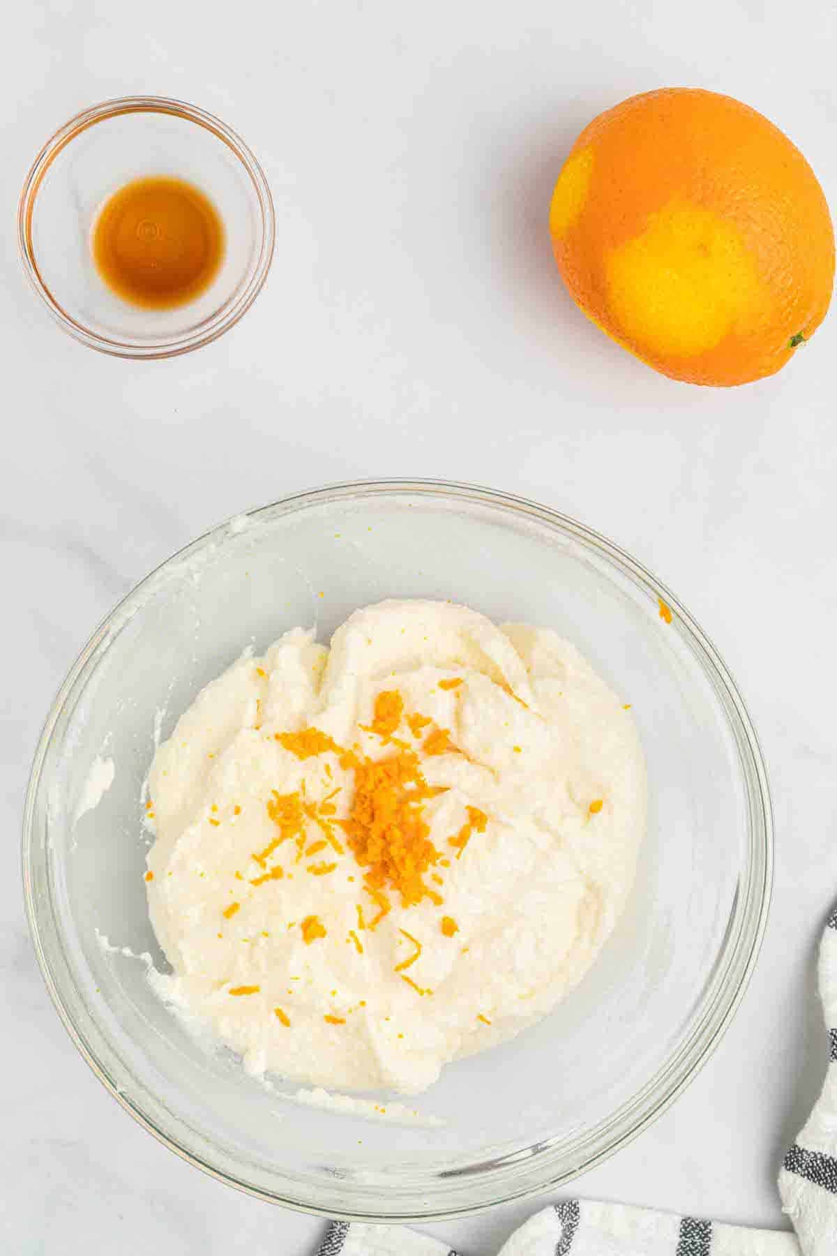 adding the orange zest to the cannoli cream mixture. 