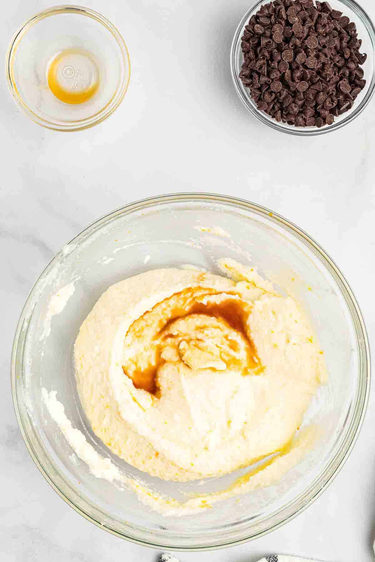 adding the vanilla to the top of the ricotta cannoli cream filling mixture.