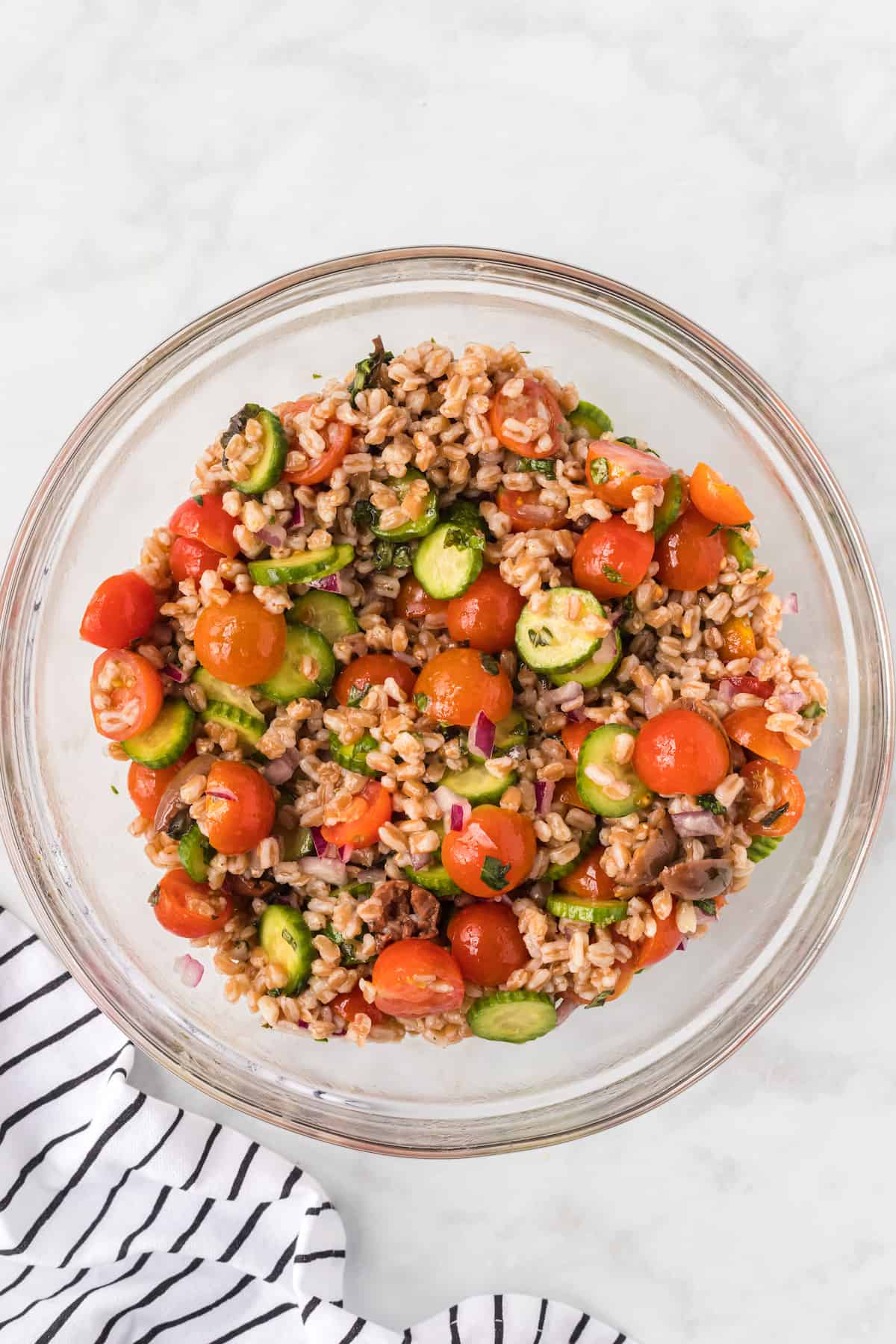 all of the vegetables combined with the cooked farro in a large bowl