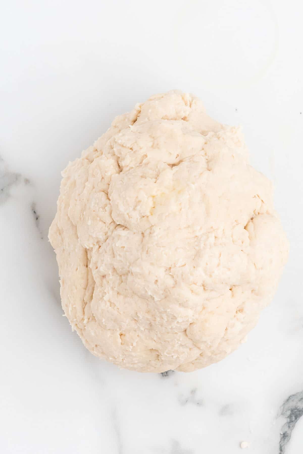 kneading the dough ball for the pizza crust.
