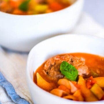 meatball soup in white bowls
