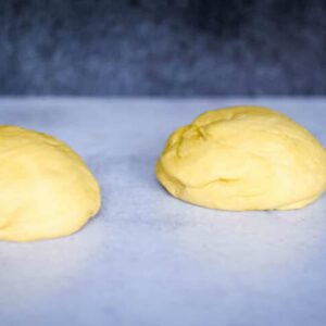 two pizza dough balls on countertop