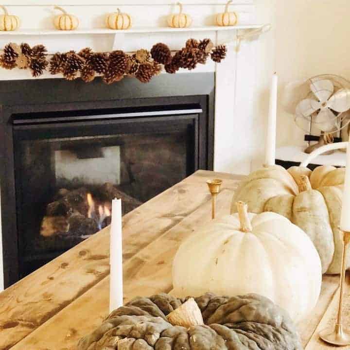white pumpkins and candles on farmhouse table