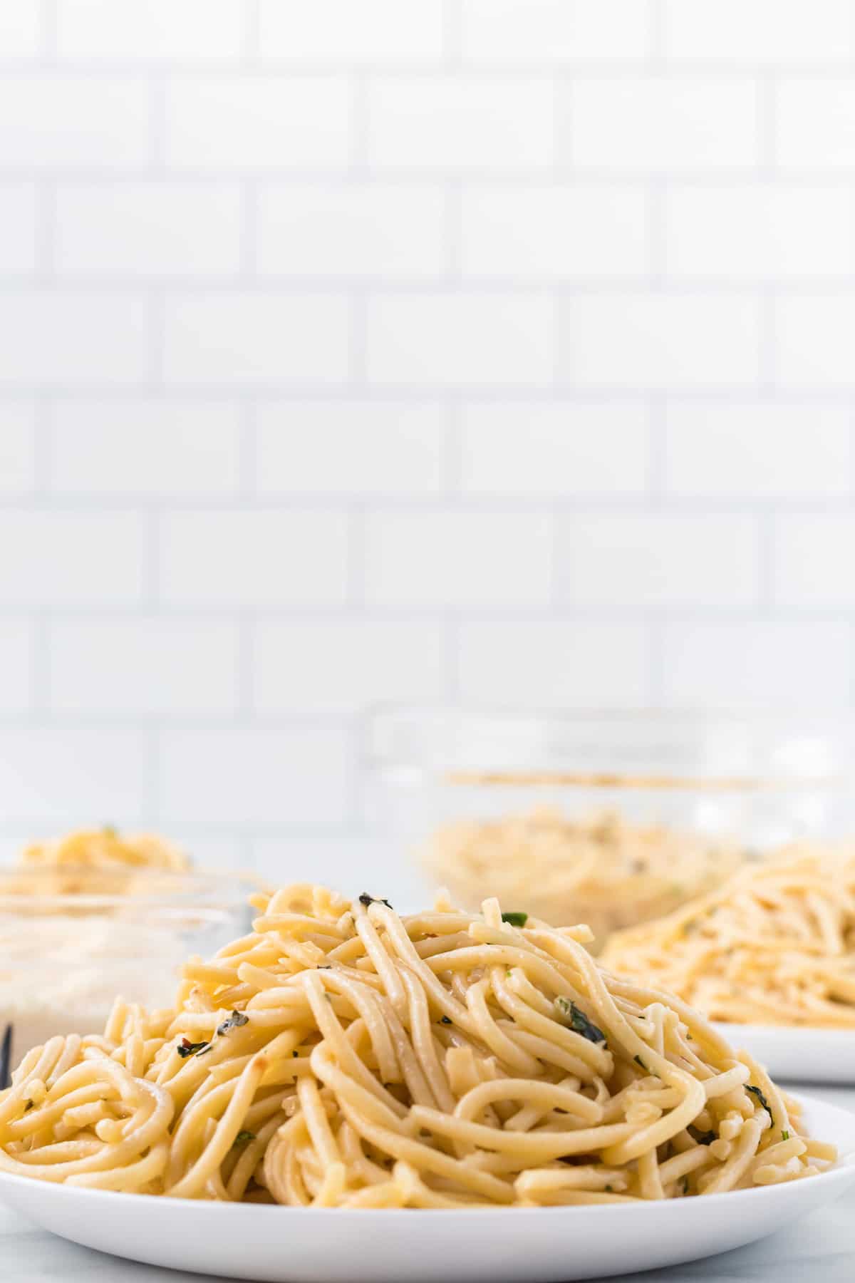 white plates with Spaghetti Aglio e oilio 