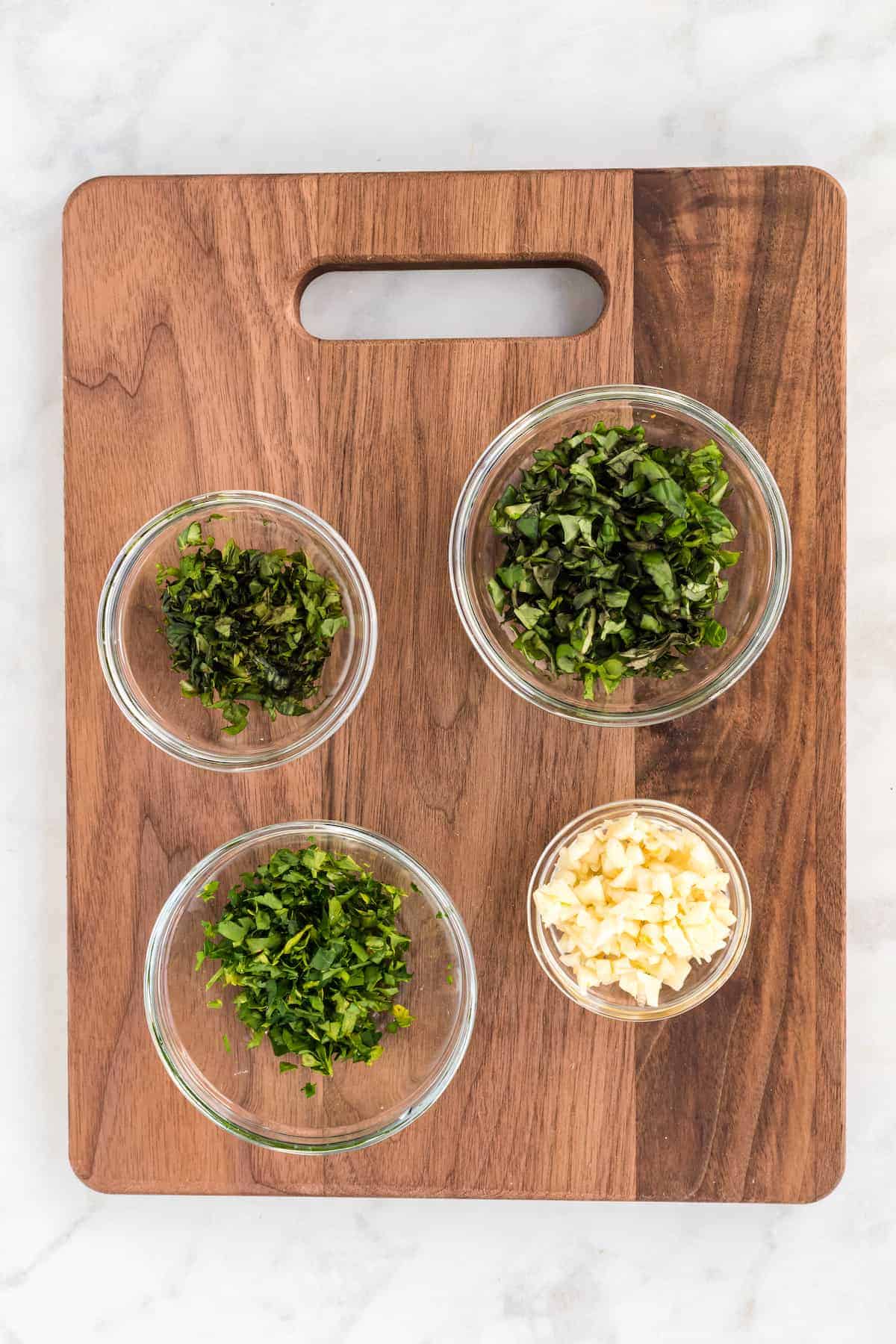 fresh herbs and garlic chopped in a bowl