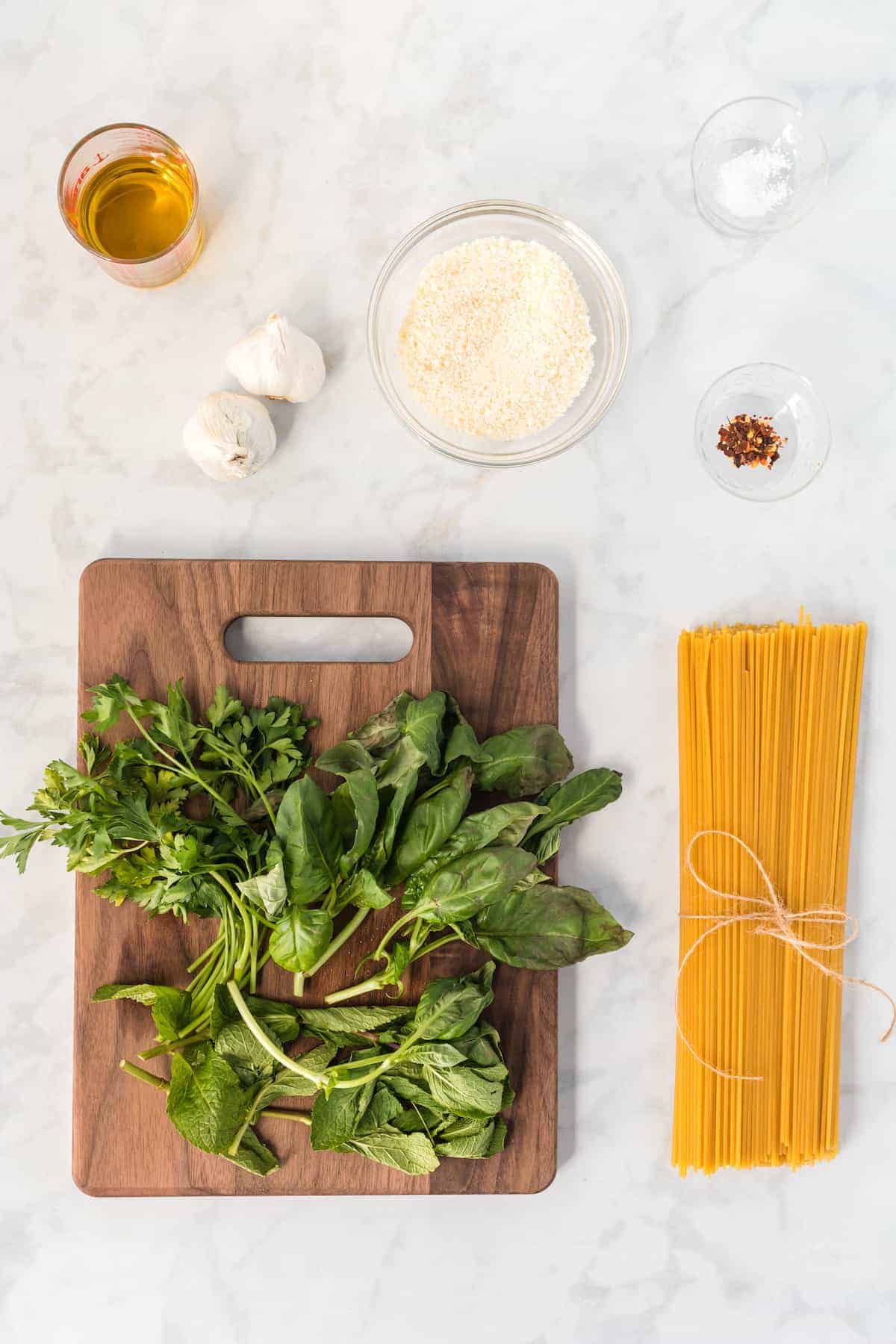 ingredients for the spaghetti in bowls and cutting board
