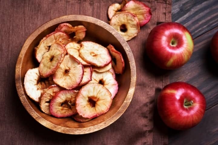 dehydrated apples in a wooden bowl