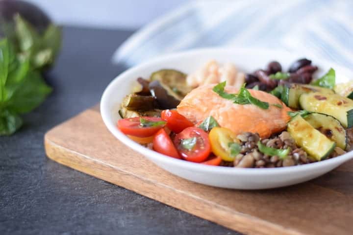 white bowl with serving of salmon grain bowl 